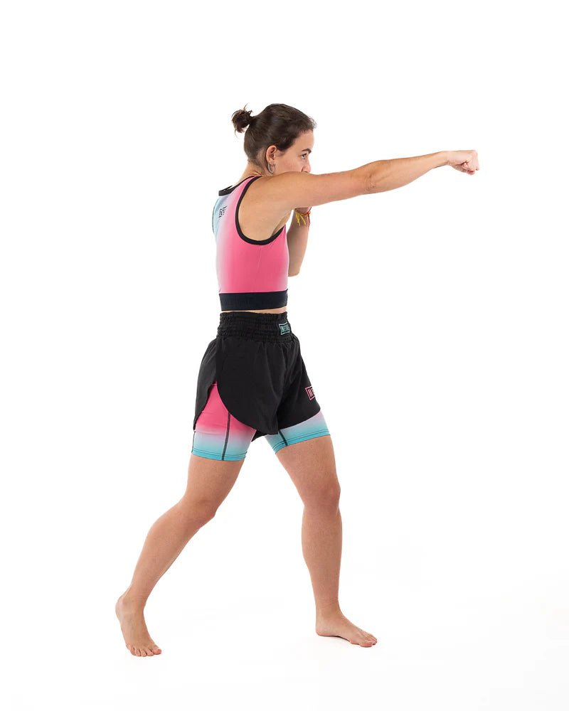 Athlete in punch action wearing the Metal Boxing Miami Vibe compression tank top, tight fit and support