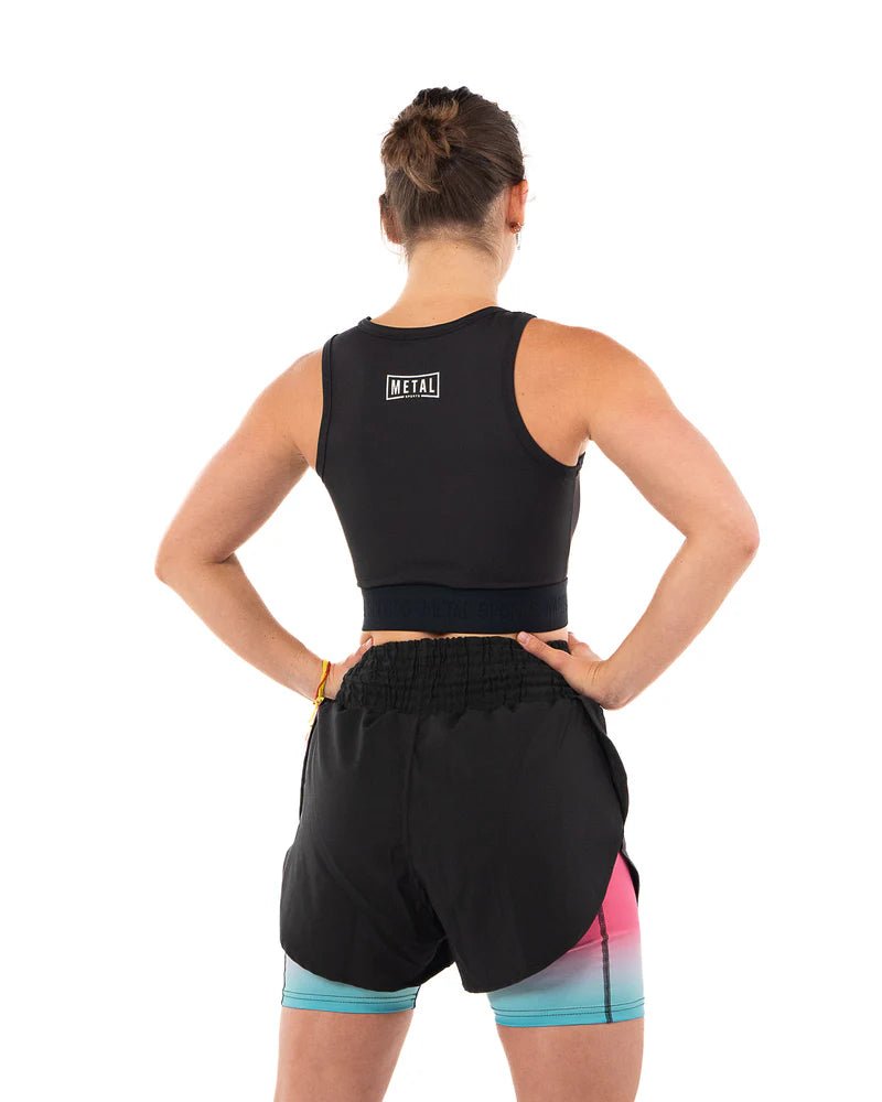 Rear view of the black Metal Boxe women's compression tank top with full back coverage
