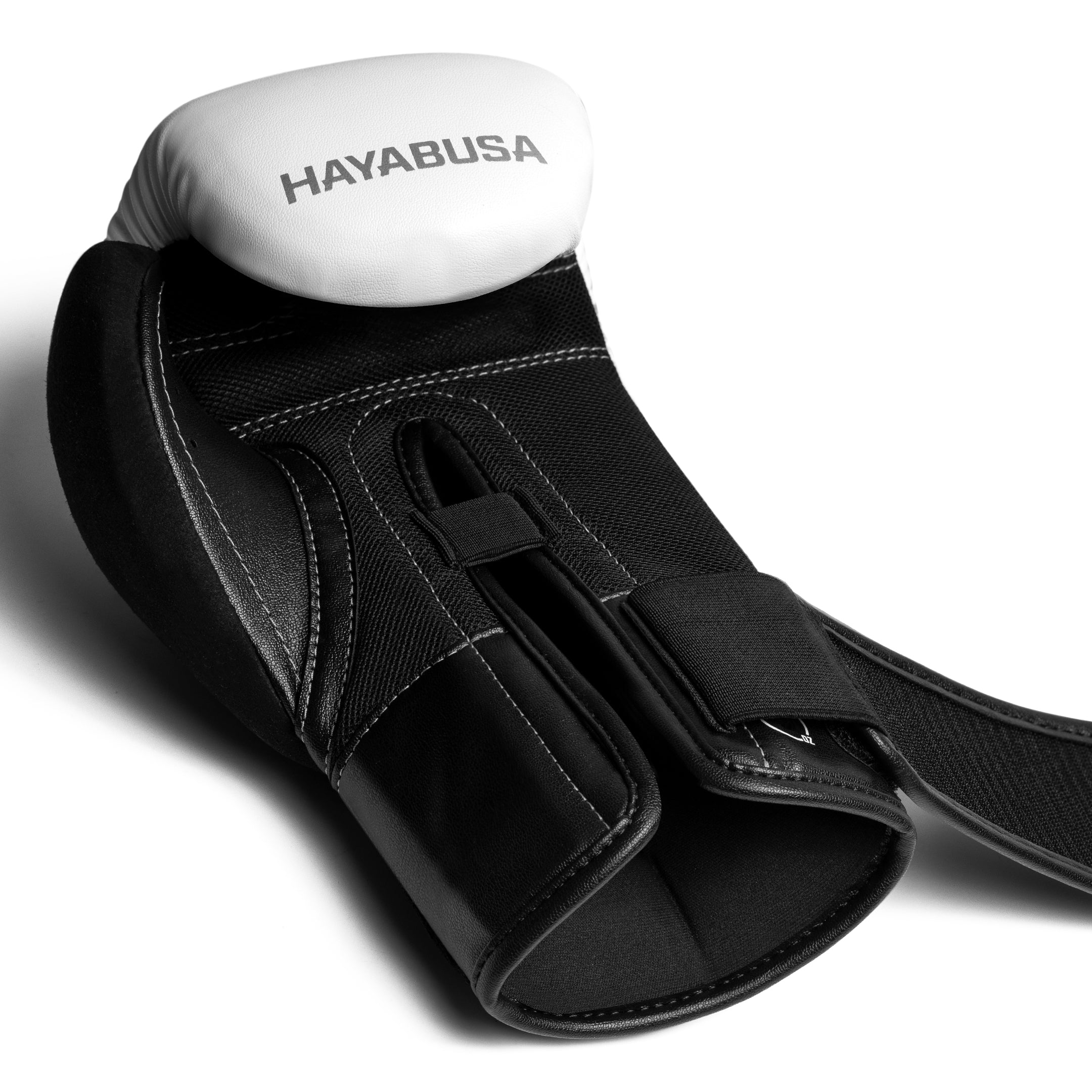 Dettaglio del guantone singolo Hayabusa E1 bianco con cinturino elasticizzato slacciato