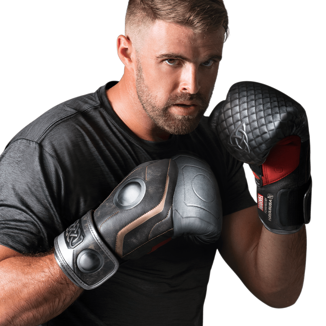 Athlete wearing brown and silver Hayabusa Marvel Thor gloves in attack position