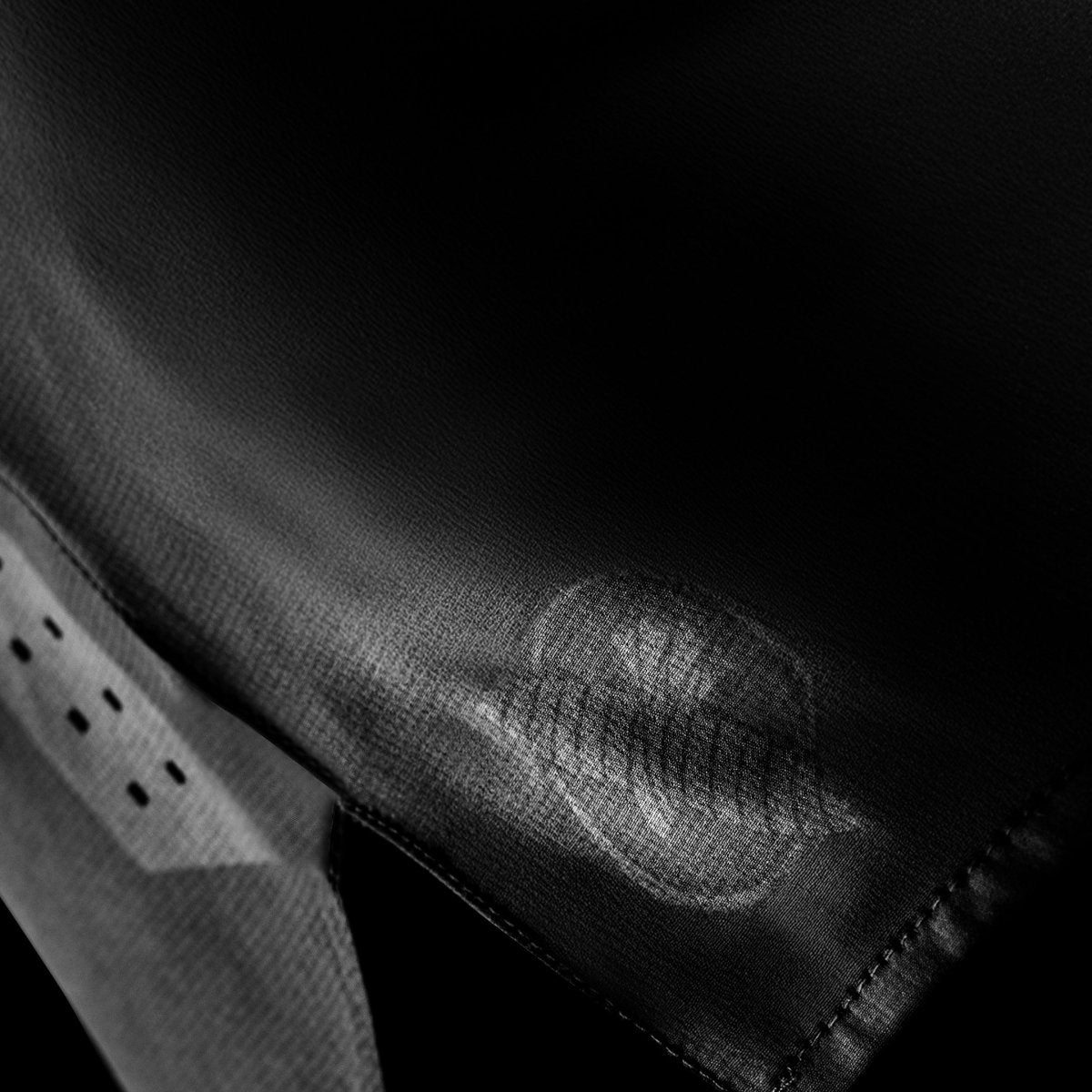 Side detail of the black Hayabusa Core grappling shorts, showing laser-cut ventilation holes