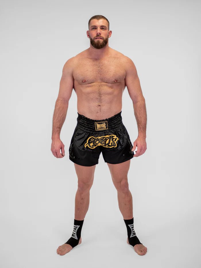 Detail des technischen Gewebes und der Verarbeitung der schwarzen Muay-Thai-Shorts für Herren von Metal Boxing