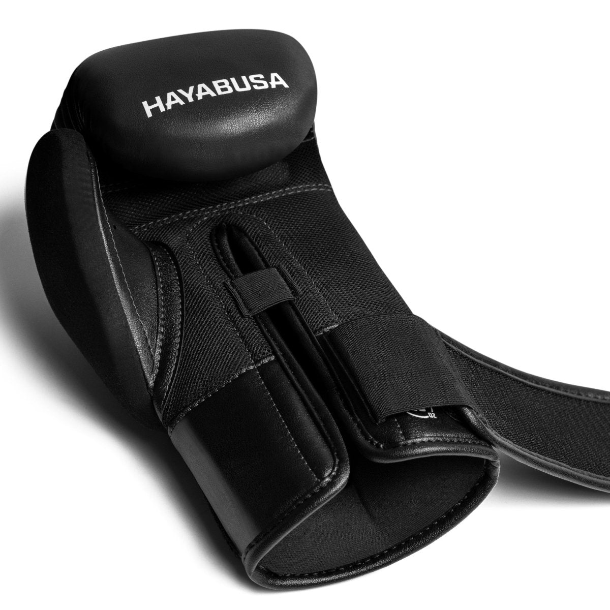 Close-up view of the unfastened closure system on the black Hayabusa E1 gloves