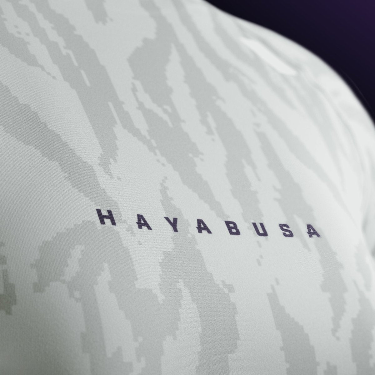 Деталь логотипа и надписи Hayabusa на груди бежевого женского рашгарда, высокопрочный принт