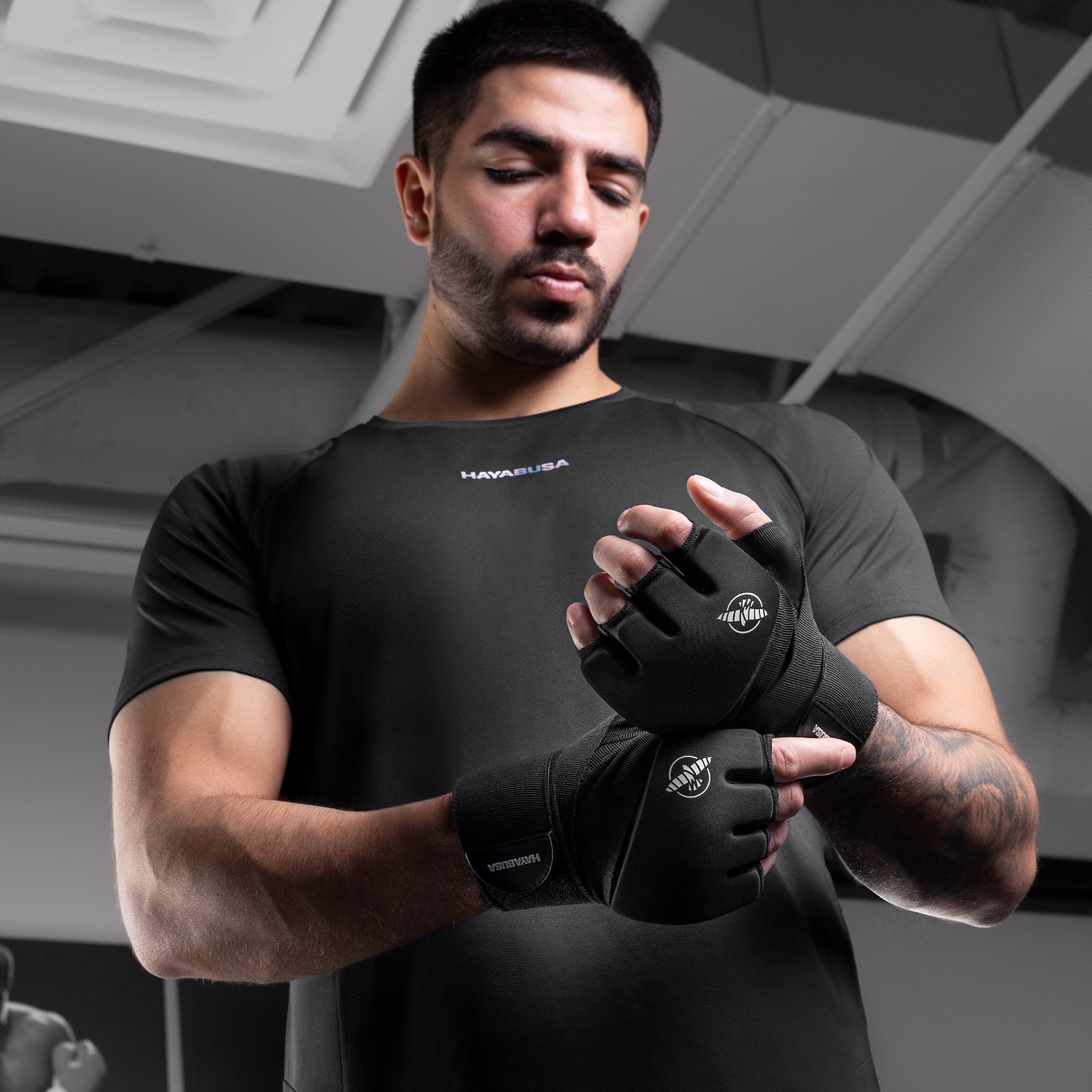 Sottoguanti neri Hayabusa Elite indossati da un uomo che mostrano il fit delle dita e la chiusura al polso